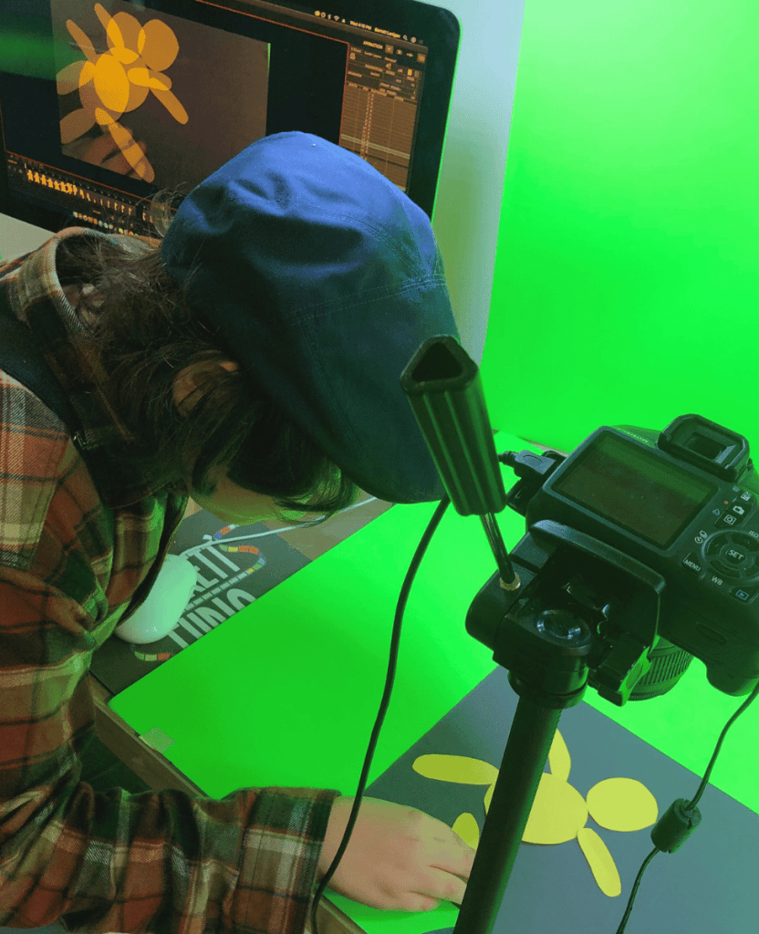 Kids animating a paper character with a DSLR camera