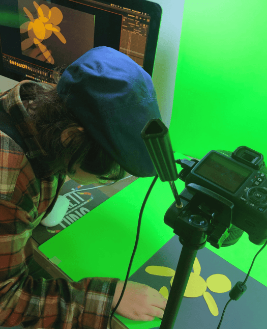 Kids animating a paper character with a DSLR camera